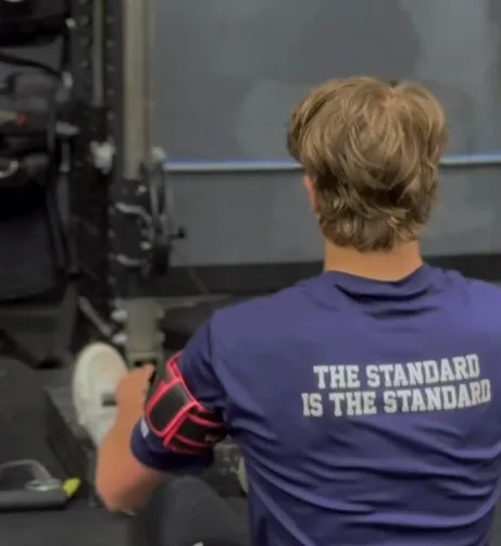 Baseball athlete using blood-flow-restriction training as part of an arm-capacity program