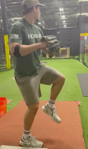 Professional pitcher progressing through mound work during return to throw