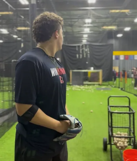 Baseball athlete preparing for a monitored return-to-throw session after Tommy John surgery