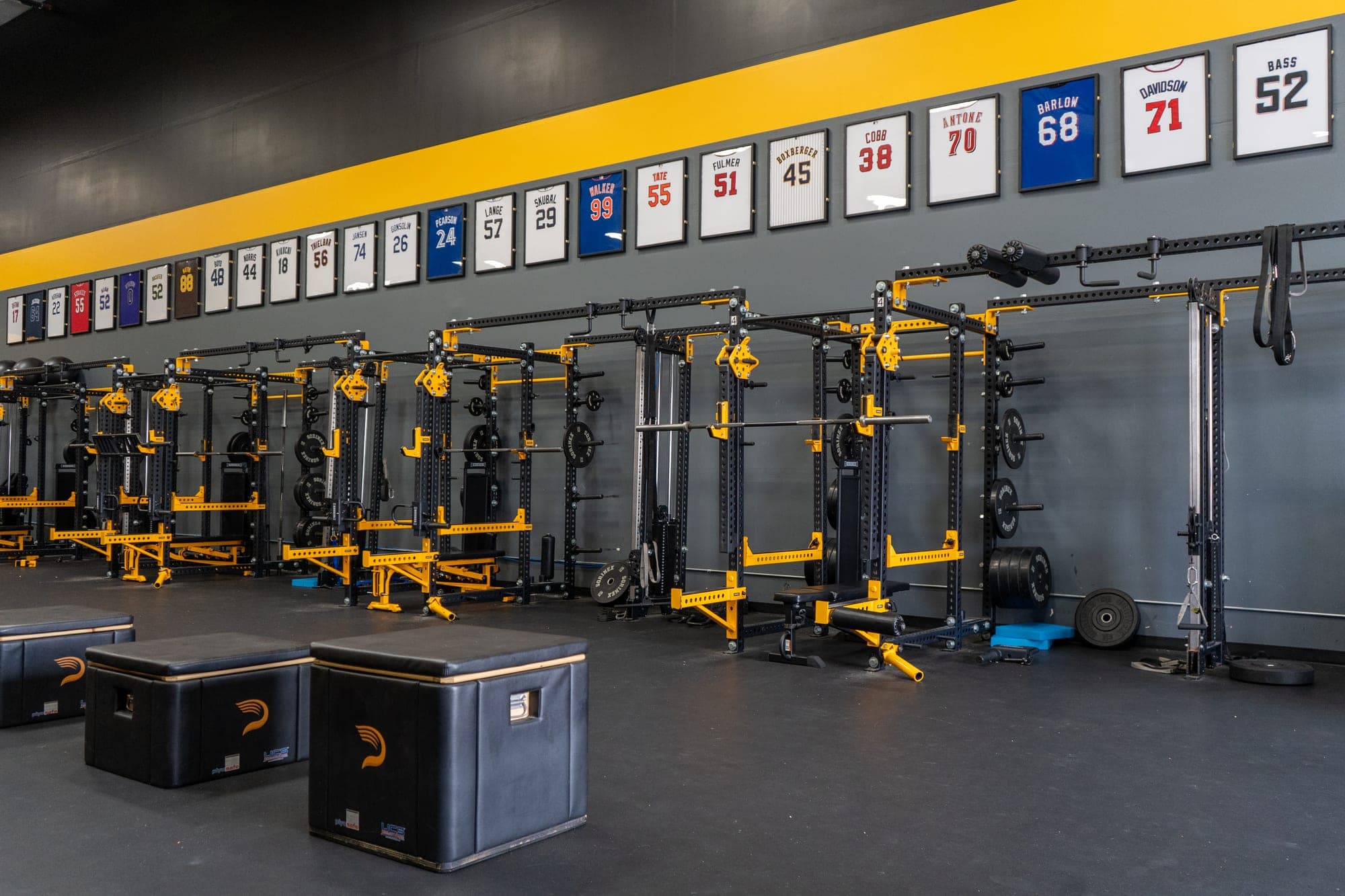 Inside Driveline Baseball facility, weight room with jersey wall